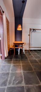 a dining room with a table and a lamp at O Caramuru Hostel - Cumuruxatiba in Cumuruxatiba