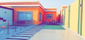 a painting of a house with a patio with chairs at Abo Naif Resort in Rayyis