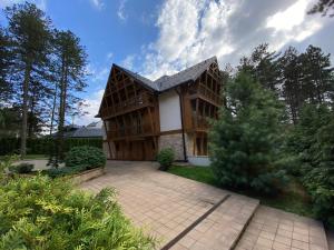 a large house with a courtyard in front of it at Rujna gora in Zlatibor