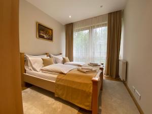 a bedroom with a large bed and a window at Rujna gora in Zlatibor