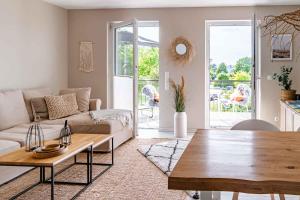 a living room with a couch and a table at Ewigsmoi in Kühlungsborn