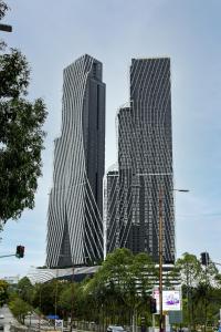 two tall skyscrapers in a city with a street at Arte Mont Kiara by Airhost in Kuala Lumpur