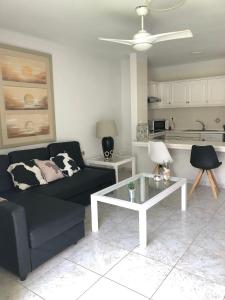 a living room with a couch and a coffee table at Apartamento de 1 dormitorio en Victoria Court 2 Los Cristianos. in Los Cristianos