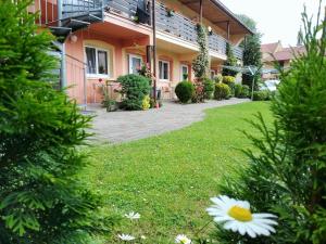 a house with a lawn in front of it at Penzion Areal Zamma in Rožňava