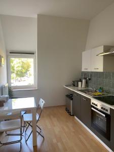 a kitchen with a table and a table and chairs at Ferienwohnungen "am Fürstenweg" in Neuwied