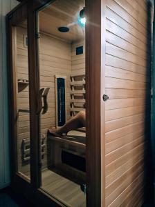 a person laying on a bed in a sauna at Family Home Garden & Sauna in Kraków