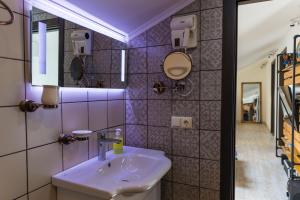 a bathroom with a sink and a mirror at TJ GARDENS in Makhinjauri