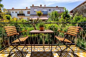 a patio with two chairs and a table on a balcony at Apartment in Rovinj/Istrien 11481 in Štanga