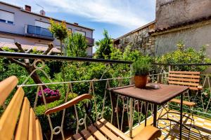 a balcony with a wooden table and chairs at Apartment in Rovinj/Istrien 11481 in Štanga