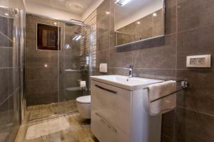 a bathroom with a sink and a toilet and a shower at One-Bedroom Apartment in Rovinj VII in Štanga