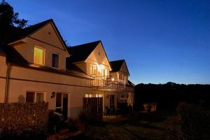 a house with lights on top of it at night at FLEESENTRAUM Seeadler Grand Maisonette - Für Golfer und Familien - Sauna Kamin Balkon Nintendo - Hunde willkommen! in Göhren-Lebbin