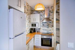 Η κουζίνα ή μικρή κουζίνα στο B - Apartamento exclusivo con piscina compartida +1 φωτογραφίες
