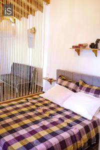 a bedroom with a bed with a plaid blanket at MY HOME in Áno Lekhónia