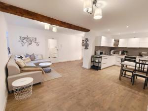 a living room and kitchen with a couch and a table at Ferienhaus Theodor EG in Laufen