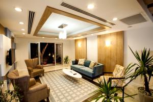 a living room with chairs and a couch and a table at Zena Hotel Bodrum in Guvercinlik +27 photos