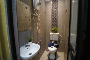 a small bathroom with a toilet and a sink at Ghazrin's Classic in Johor Bahru