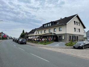 a large white building with cars parked on the side of a street at Hotel Akropolis in Herford