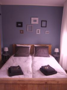 a bed with pillows and a night stand at Oekepoek Down Town in Enschede