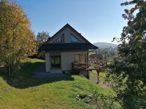 a small house sitting on top of a hill at Dwie Owce in Istebna