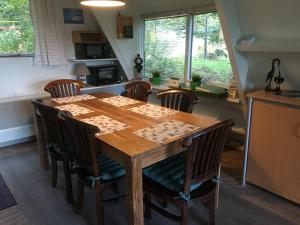 a kitchen with a wooden table and chairs at Durbuy chalet 65 in Durbuy