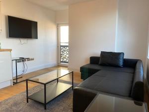 a living room with a couch and a glass table at City Centre Duplex Sleeps 4 #H9 in Hull