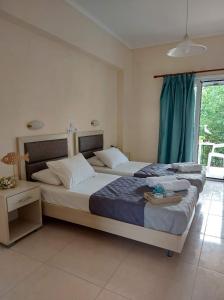 a bedroom with two beds and a window at Antonio Studios in Alikanas