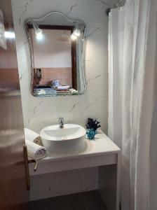 a bathroom with a sink and a mirror at Antonio Studios in Alikanas