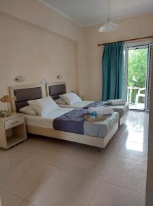 a bedroom with a large bed and a large window at Antonio Studios in Alikanas