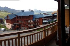 a view of a city from a balcony at Residence Le Lac Blanc in Val Thorens