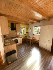 a kitchen and dining room with a wooden ceiling at Ferienhaus "Am Bergblick" Sebnitz in Sebnitz +56 photos