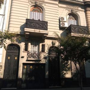 a white house with black gates and windows at Hotel Tango Club 2 in Buenos Aires +28 photos