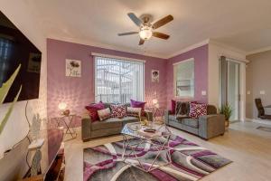 a living room with a ceiling fan and purple walls at NEWLY LISTED Townhouse Storey Lake, Free Waterpark in Kissimmee