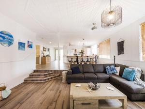
a living room with a couch and a table at 31 Melville Street in Iluka

