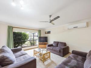 a living room with two couches and a tv at Armorel at Iluka in Iluka