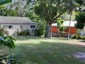 a house and a yard with a tree at Bayview at Iluka in Iluka