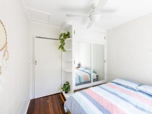 
a bedroom with a bed and a dresser at Greenwood House in Iluka
