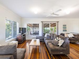 a living room with a couch and a table at Greenwood House in Iluka