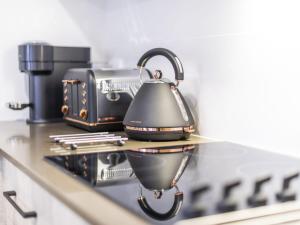 a tea kettle on a counter in a kitchen at Iluka Villa 2 in Iluka