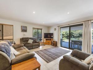 
a living room filled with furniture and a fireplace at Lillypilly in Iluka

