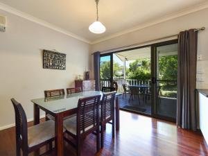 a kitchen and dining room with a table and chairs at Rhijac at Iluka in Iluka