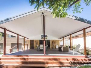a pavilion with a roof with a table and chairs at Ripples on the Bay in Iluka