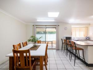 
a dining room table and chairs in a room at Rainforest Retreat in Iluka
