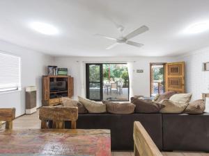 
a living room filled with furniture and a tv at Ripples on the Bay in Iluka
