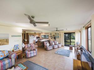 a large living room with couches and a kitchen at Unit 4 Orana in Iluka