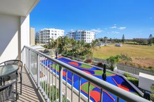 
a view from a balcony of a building with a view of the ocean at The Point Resort in Bargara
