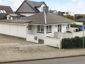 a white house with a fence in front of it at 2 person holiday home in Esbjerg V in Esbjerg