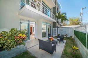 a house with a patio with chairs and plants at Flamingo Zueños del Mar Condominiums in Playa Flamingo