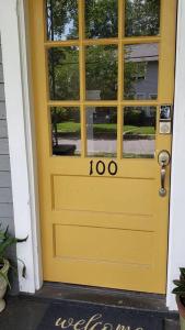 a yellow front door of a house at The Lafayette House in Mobile