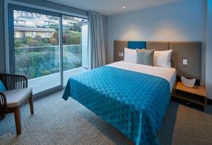 a hotel room with a bed and a large window at mi-pad Queenstown in Queenstown