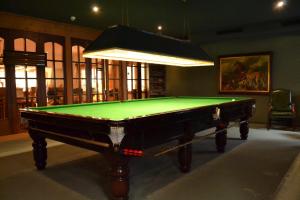 a pool table in a room with a light at Waldhotel Doldenhorn in Kandersteg